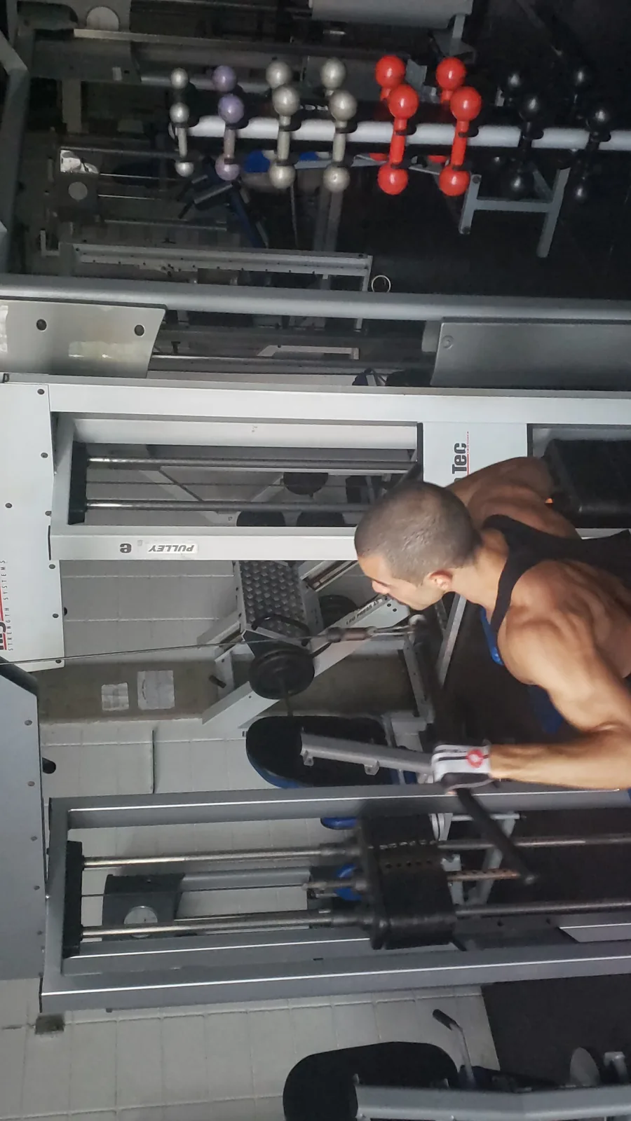 Raphael doing arm training on a gym machine