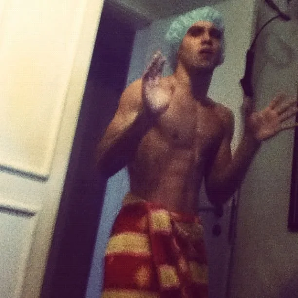 Raphael in a shower cap and a striped towel, waving