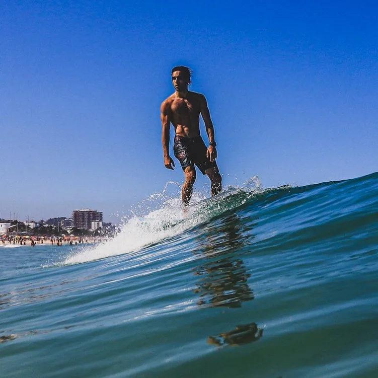 Raphael surfing a wave